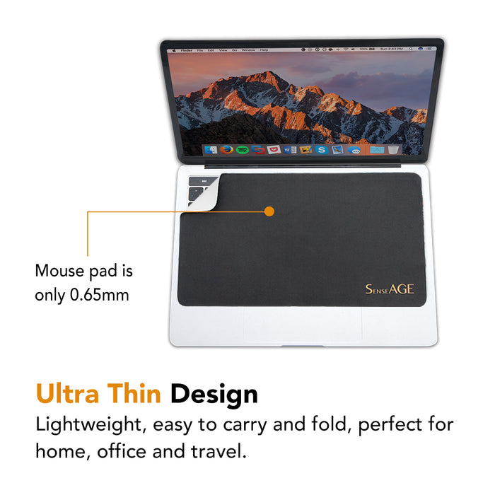 SenseAGE mouse pad placed on a MacBook keyboard, with a small section lifted to show its thinness. Text reads 'Mouse pad is only 0.65mm' and 'Ultra Thin Design: Lightweight, easy to carry and fold, perfect for home, office, and travel.' The SenseAGE logo is visible on the mouse pad.